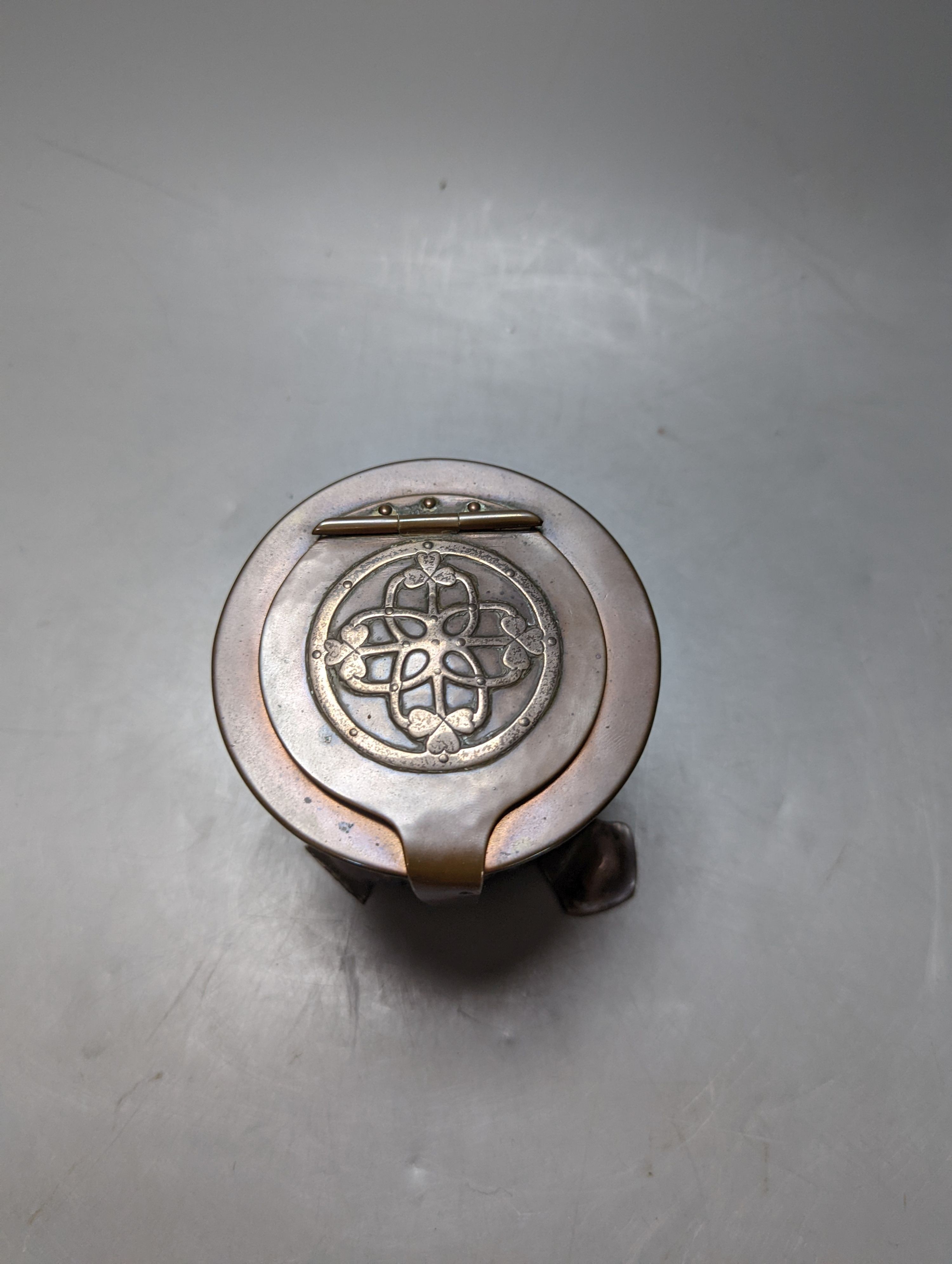 An Arts and Crafts copper and white metal inkwell, unsigned, 9 cms high.